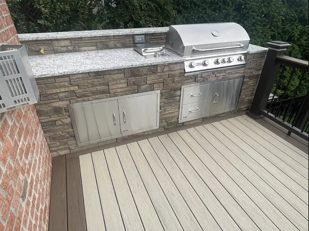 Phot of an outdoor kitchen with countertops and storage areas.